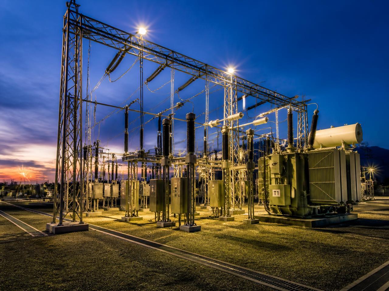 110/33 kV pooling substation switchyard with power transformer at dusk